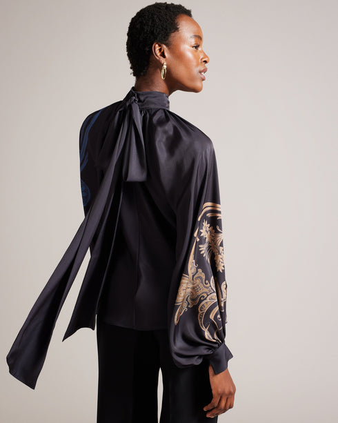 TESSAAH-Tops-When the evening calls for a nice top, TESSAAH is the go-to. Featuring our luxe gilded floral print and an oversized neck tie that brings drama to the silhouette, this blouse is both elegant and easy to wear. Satin blouse Blouson sleeves High neck Ombre gilded floral print Oversized neck tie Gathered neckline Zip fastening Silvia is 5'11" / 1.8m and wears Blue in a Ted size 1- Ted Baker Romania
